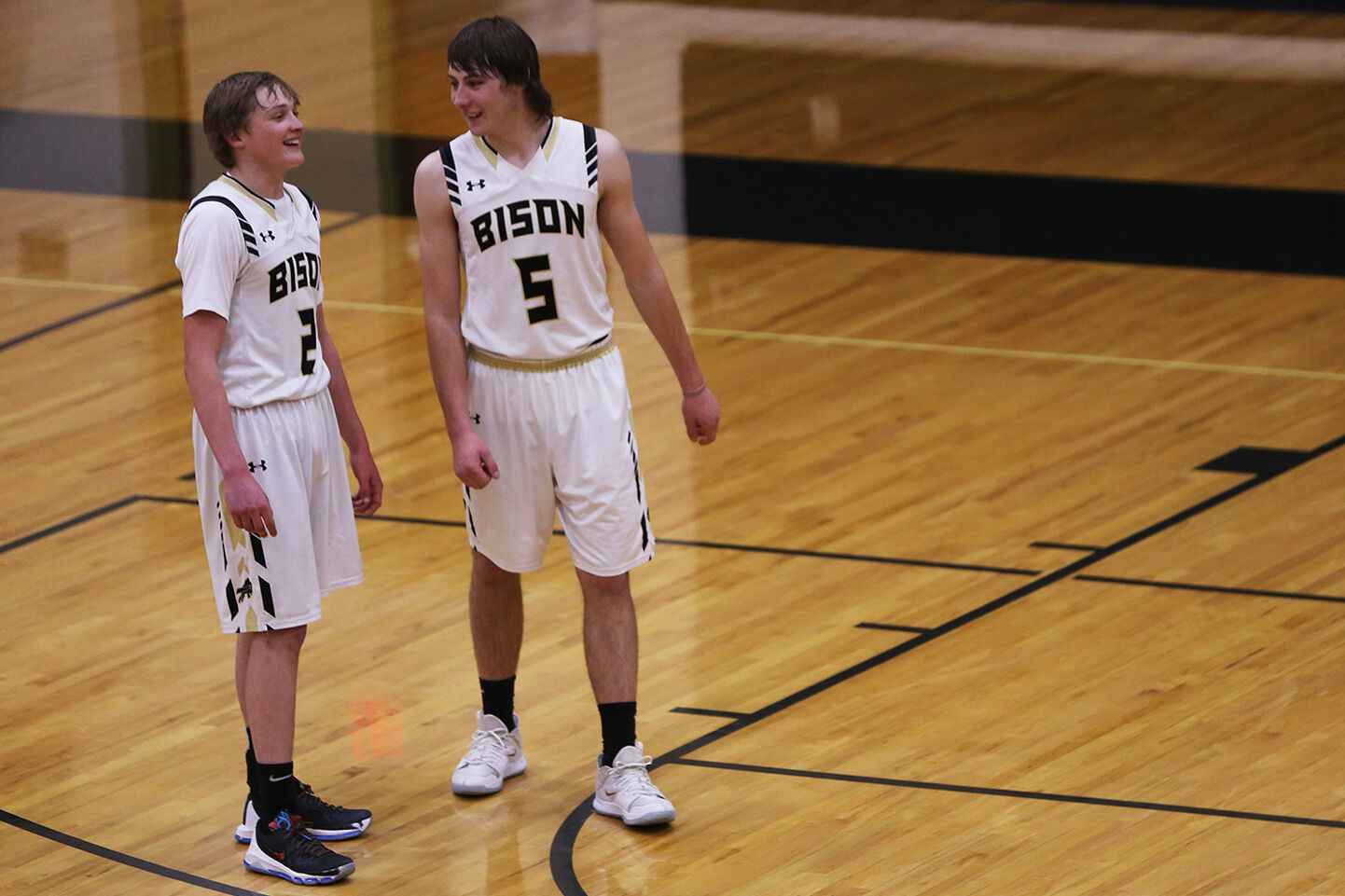 Coy Johnson and Hunter Stone laugh together after a timeout